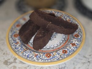 Plate of chocolate biscotti on a decorative plate.