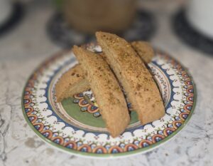 Three pieces of biscotti on a decorative plate.
