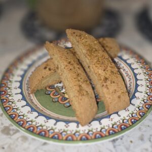 Three pieces of biscotti on a decorative plate.