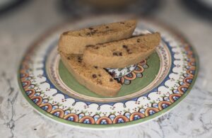 Three biscotti pieces on a decorative plate.