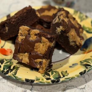 Plate of brownies with peanut butter swirl on a floral plate.