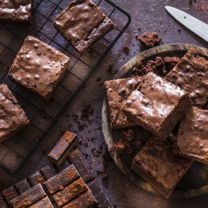 Delicious chocolate brownies on a cooling rack and plate.