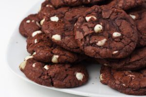 Plate of chocolate cookies with white chocolate chips.