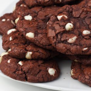 Plate of chocolate cookies with white chocolate chips.