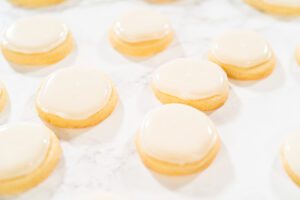 Cream-filled cookies arranged on a white surface.