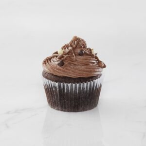Chocolate cupcake with rich chocolate frosting and chocolate pieces on top.