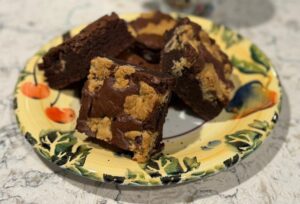 Plate of homemade brownies with peanut butter swirls.