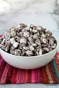 Bowl of powdered sugar-coated snack mix.